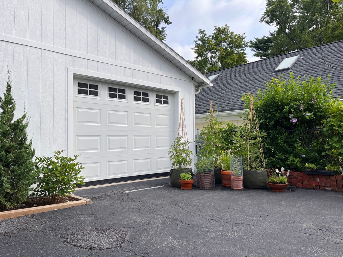 Vegetable container garden in front of garage door