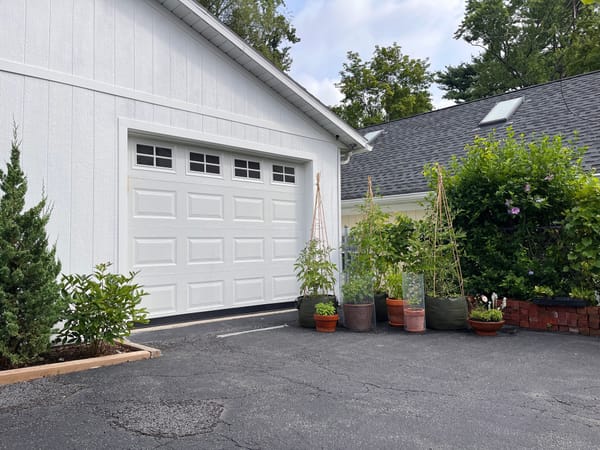 Vegetable container garden in front of garage door